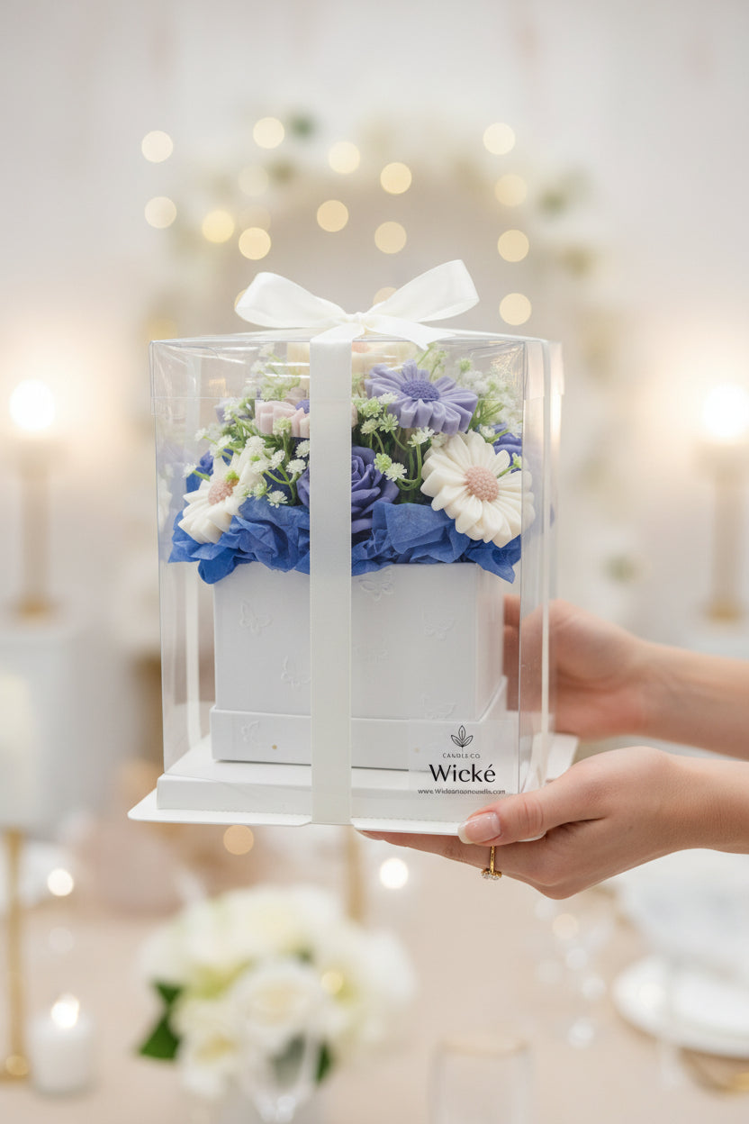 Floral arrangement in a clear box with 'Wicke' branding on a white background