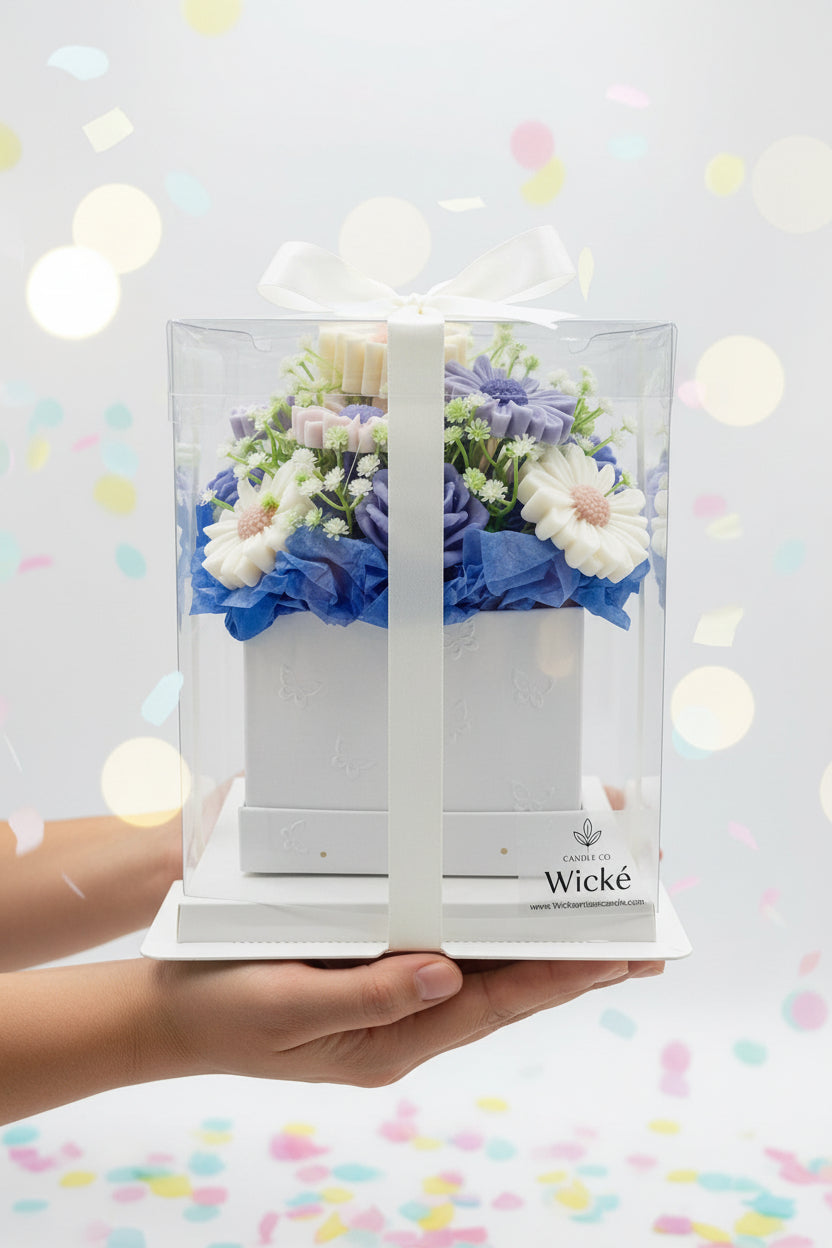 Floral arrangement in a clear box with 'Wicke' branding on a white background