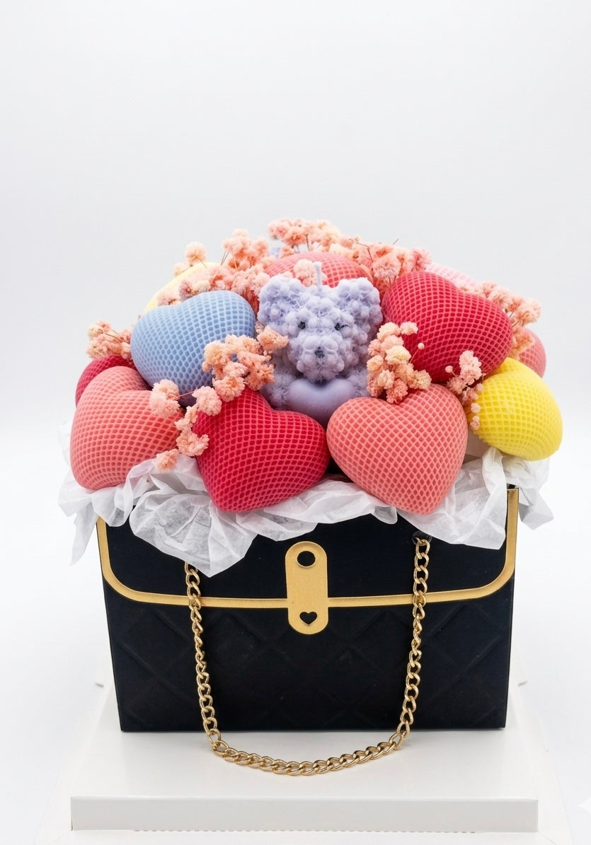 Black handbag with colorful heart-shaped flowers on a white background