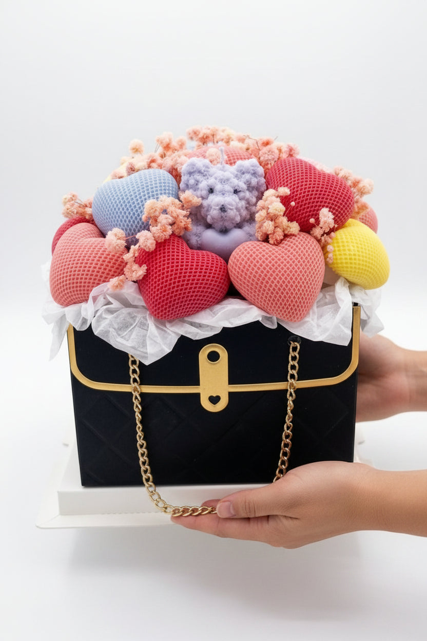 Black handbag with colorful hearts and teddy bears on a white background