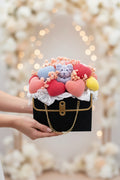 Black handbag with colorful hearts and teddy bears on a white background