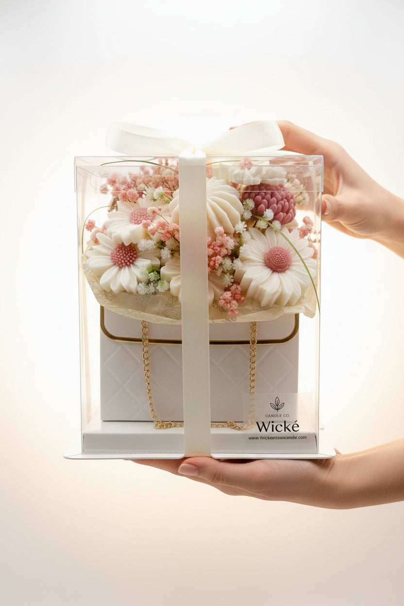 Wicke candle with floral design and gold chain in packaging on a white background