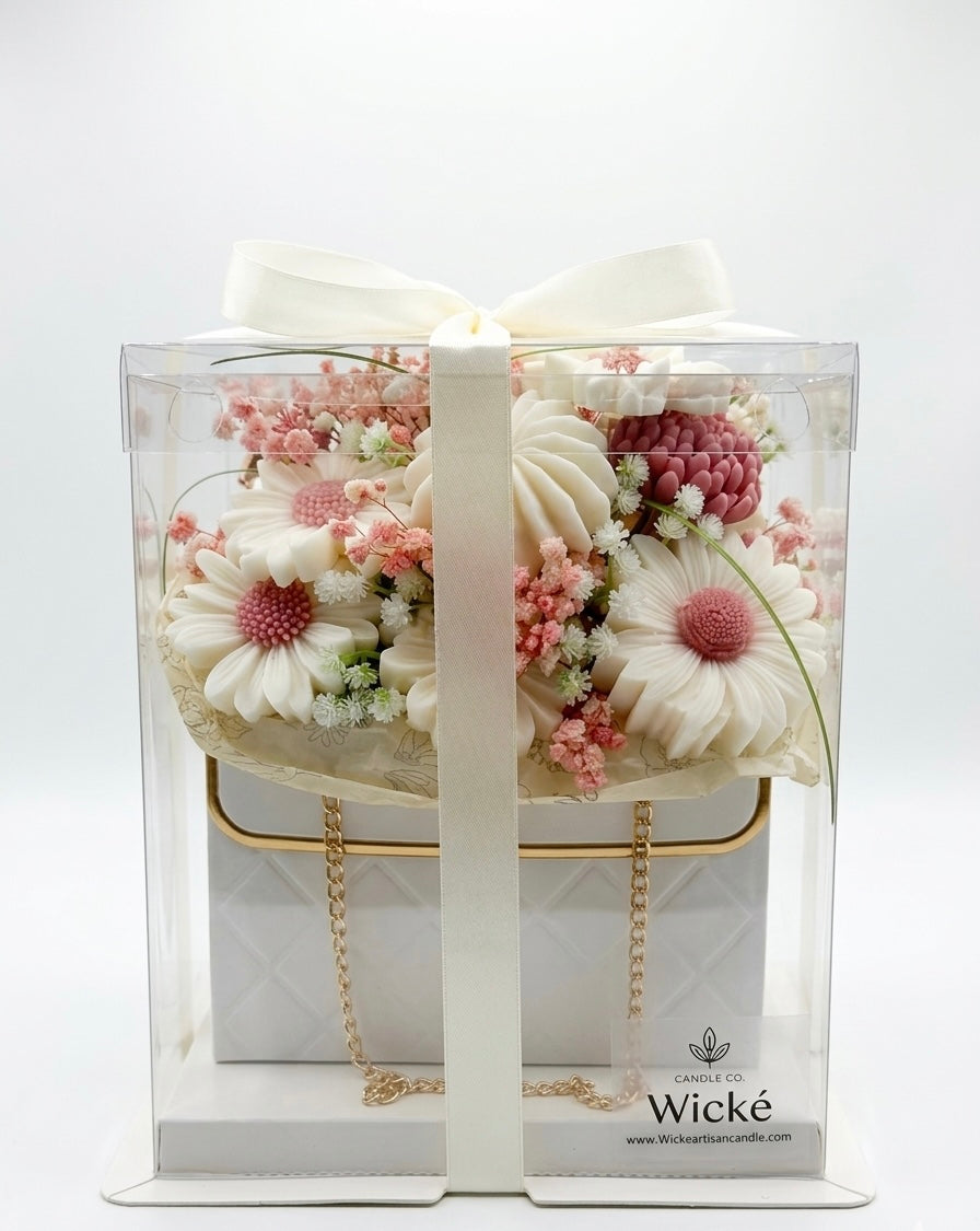 Wicke candle with floral design and gold chain in packaging on a white background