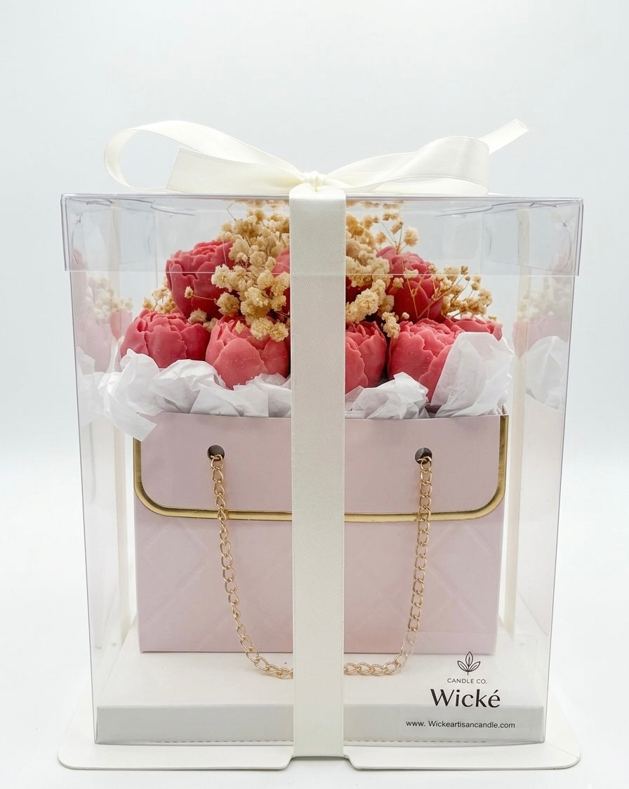 Floral arrangement in a decorative box with 'Wicke' branding on a white background