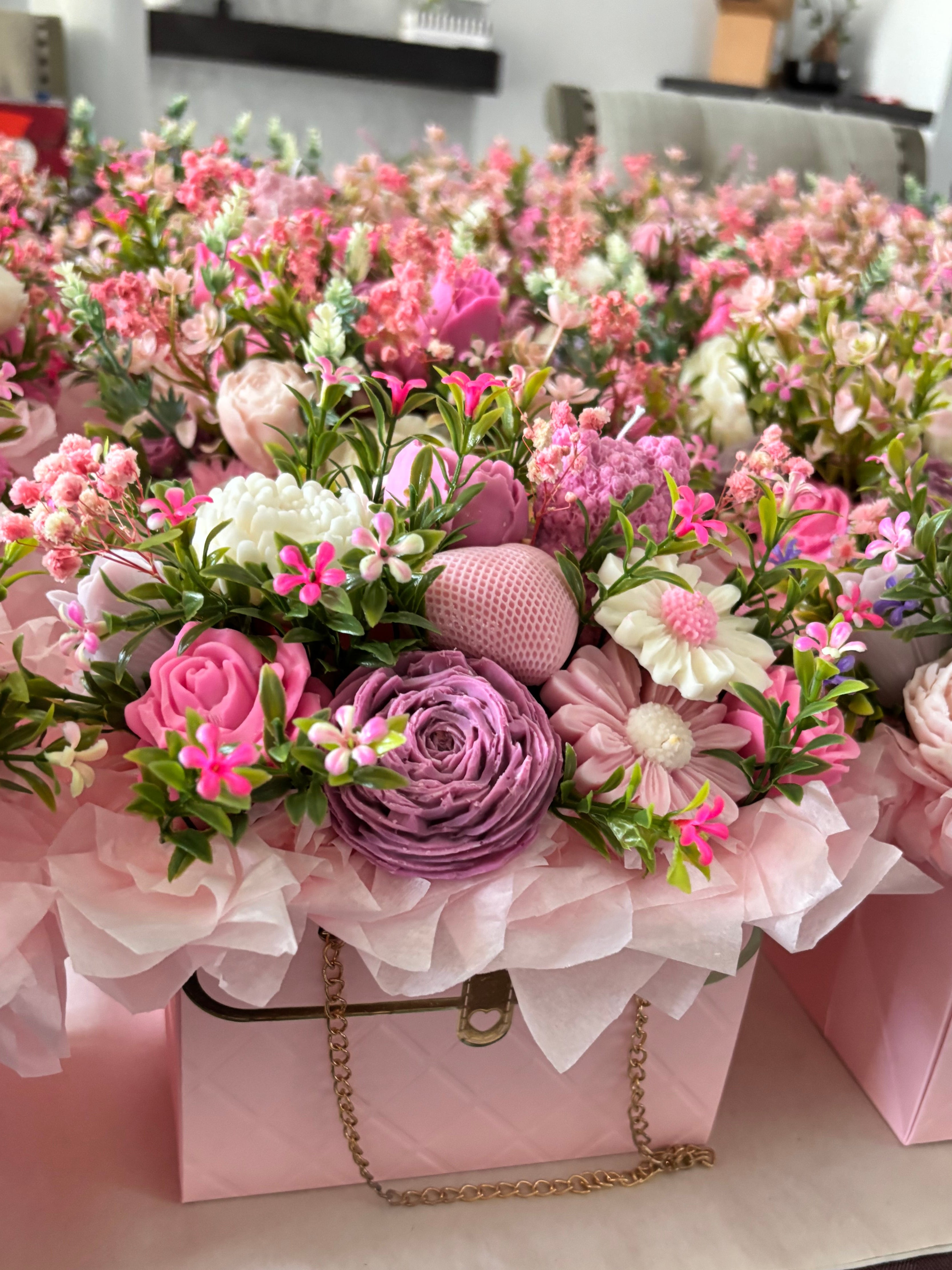 A collection of luxury floral purse candles in multiple color palettes arranged neatly as premium wedding favors and bridesmaid proposal gifts.